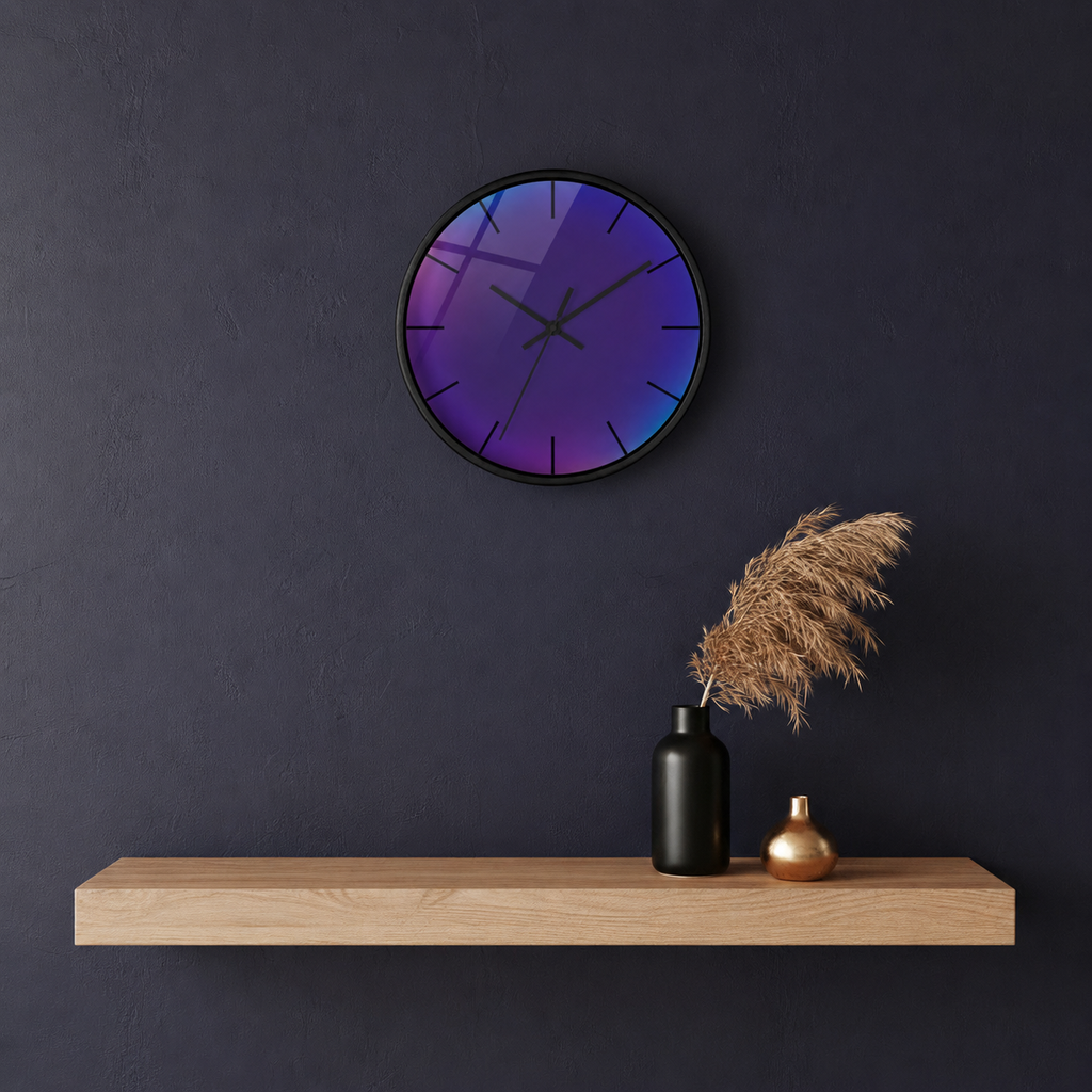 “Las Vega Afterlight” modern round wall clock with glossy glass finish displayed in a dark minimalist interior. The clock features vibrant purple, blue, and magenta gradient reflections, creating a futuristic neon-inspired aesthetic above a floating wooden shelf with decorative vases and pampas grass.