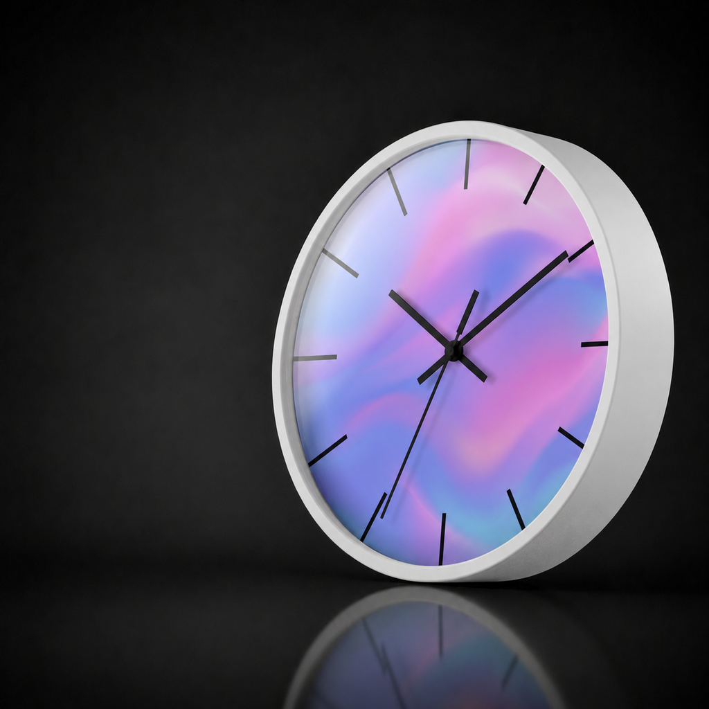 Soft Aura round wall clock by HOUR1207 with a white frame, black hour markers and a pastel pink, lavender, blue and aqua dial on a dark studio background.